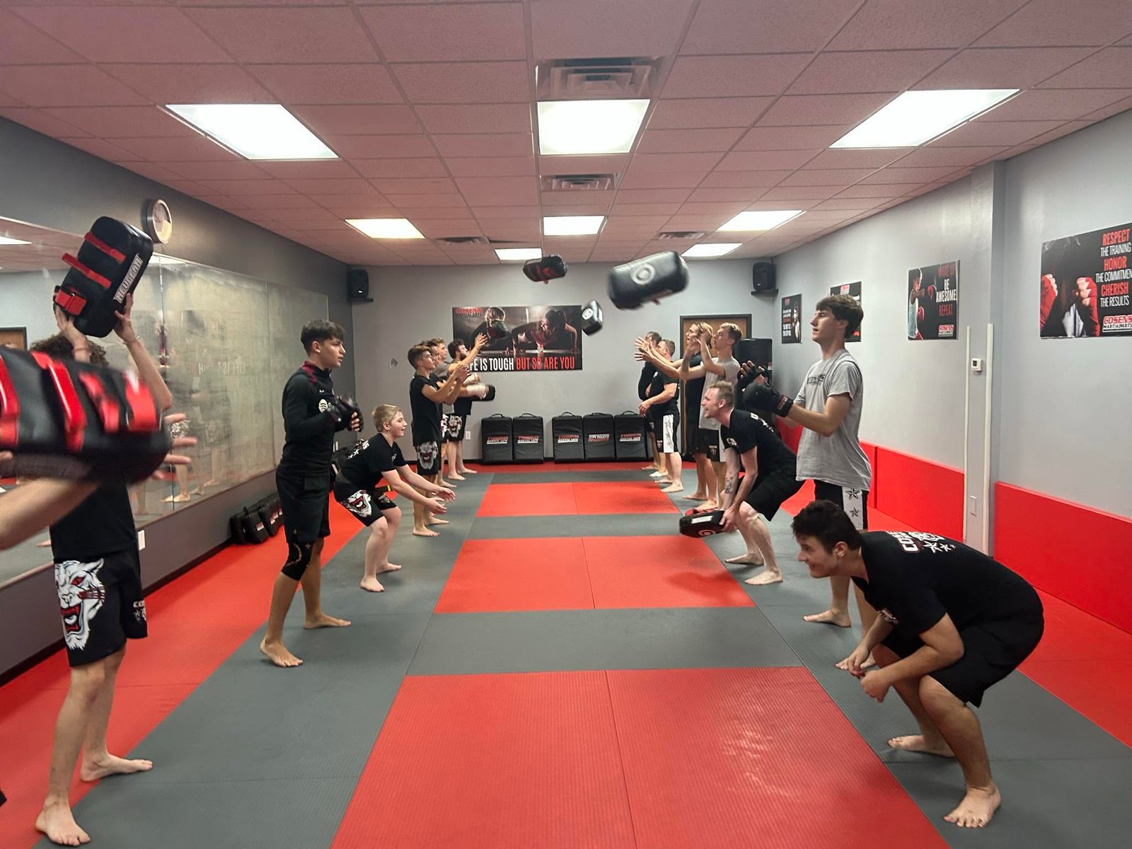 Adult MMA students having fun during an energetic training drill